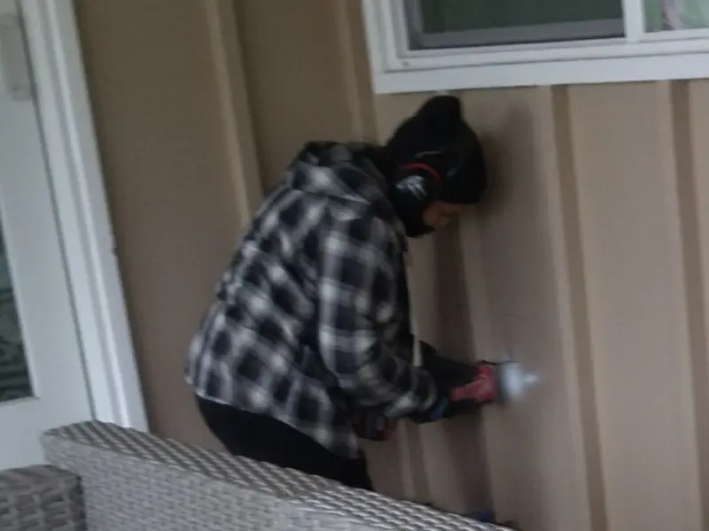 Professional electrician installing an exterior outlet in White